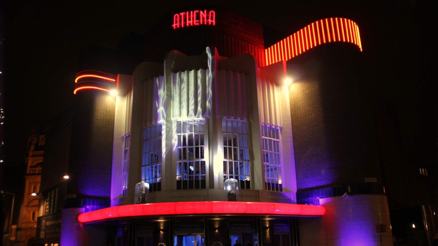 The illuminated Art Deco exterior of The Athena in Leicester at night