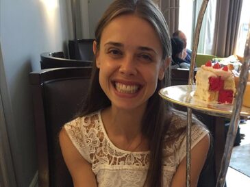 Maria smiling at a table set for afternoon tea