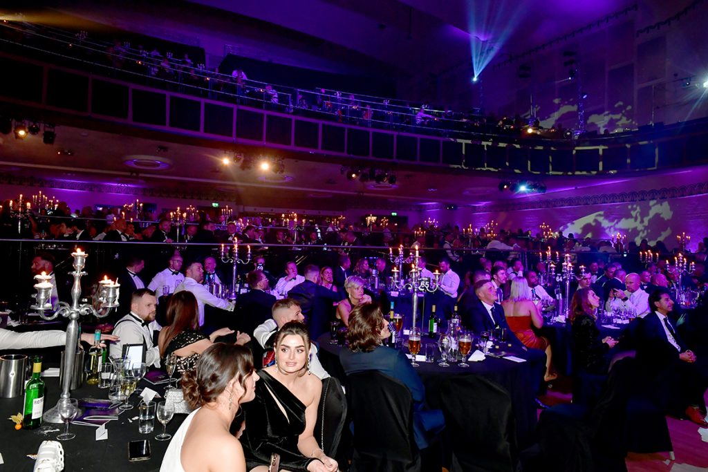 Guests seated at candlelit tables during a National Fitness Awards ceremony